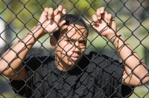 AfAm male behind fence